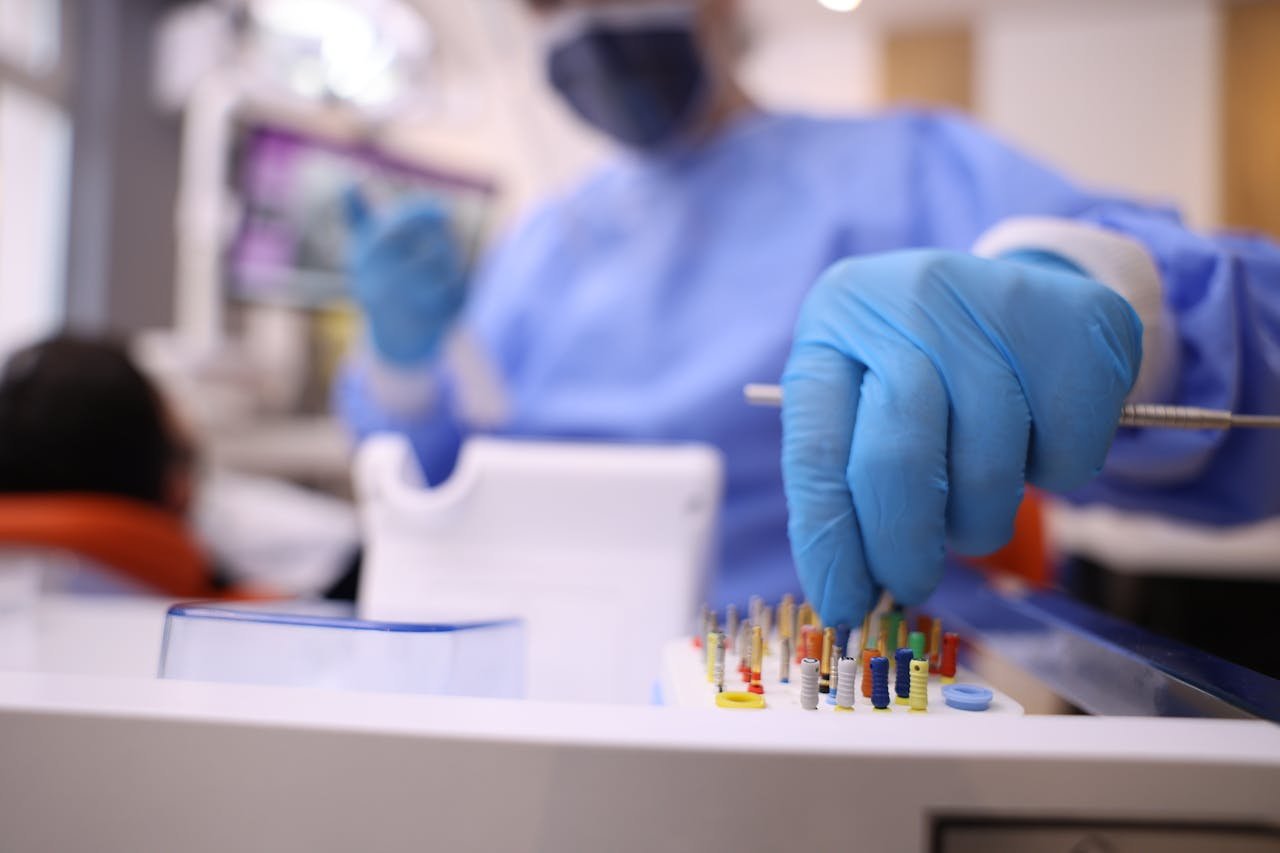 Close-up of dentist with gloves preparing dental tools for patient operation in modern clinic.